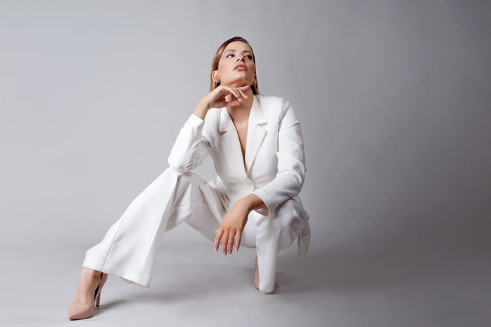 Model in a white pantsuit